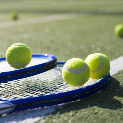 close up tennis rackets balls ground 768x513